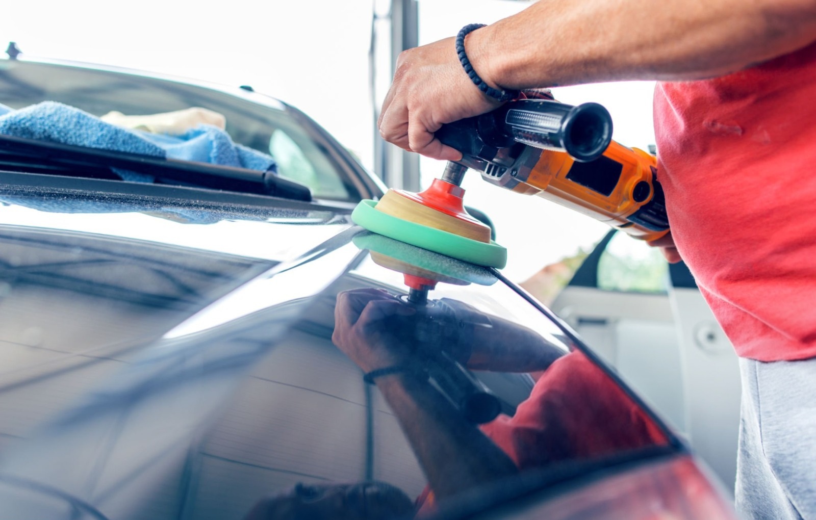 Technician detailing and polishing a vehicle